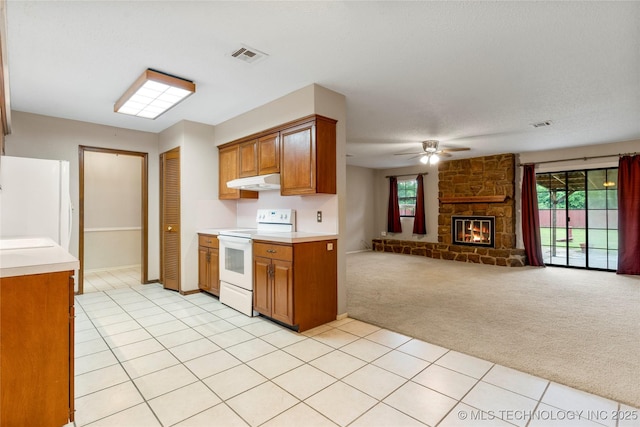 816 N Birch St, Jenks, OK 74037 - kitchen featuring white appliances, under cabinet range hood, brown cabinetry, light carpet, and light countertops