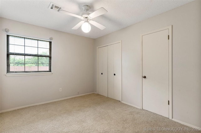 816 N Birch St, Jenks, OK 74037 - unfurnished bedroom featuring carpet, a textured ceiling, a closet, and a ceiling fan