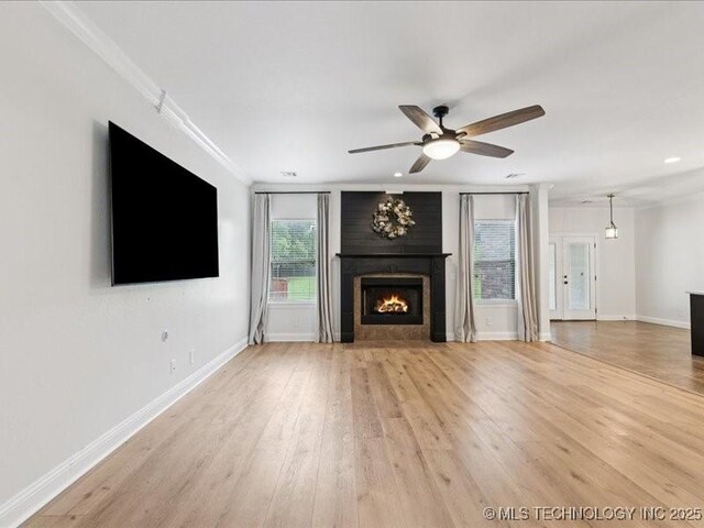 19345 S Fieldstone Dr E, Claremore, OK 74017 - unfurnished living room featuring a fireplace, a ceiling fan, crown molding, light wood-type flooring, and recessed lighting