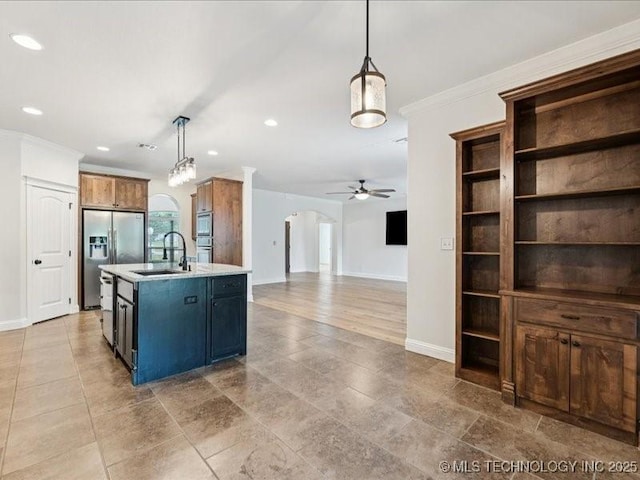 19345 S Fieldstone Dr E, Claremore, OK 74017 - kitchen with arched walkways, stainless steel appliances, ceiling fan, recessed lighting, and an island with sink