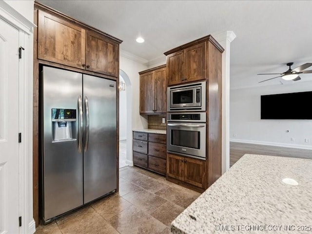 19345 S Fieldstone Dr E, Claremore, OK 74017 - kitchen with stainless steel appliances, crown molding, arched walkways, ceiling fan, and recessed lighting