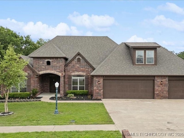 19345 S Fieldstone Dr E, Claremore, OK 74017 - view of front of home featuring brick siding, concrete driveway, a front yard, and roof with shingles