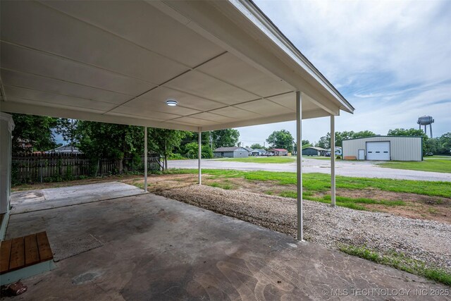 211 N 3rd St, Davis, OK 73030 - view of patio featuring an outbuilding, a carport, and driveway