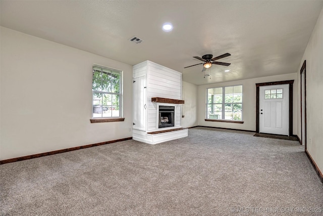 211 N 3rd St, Davis, OK 73030 - unfurnished living room featuring carpet flooring, ceiling fan, a fireplace with raised hearth, and recessed lighting