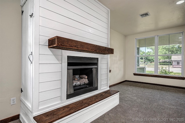 211 N 3rd St, Davis, OK 73030 - unfurnished living room featuring carpet floors and a fireplace with raised hearth