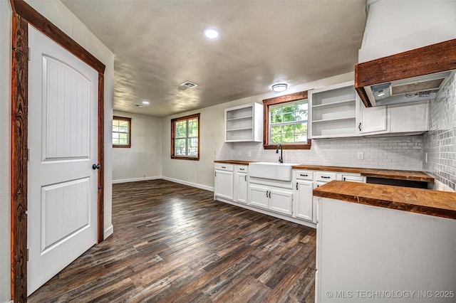 211 N 3rd St, Davis, OK 73030 - kitchen with butcher block counters, open shelves, dark wood finished floors, premium range hood, and tasteful backsplash
