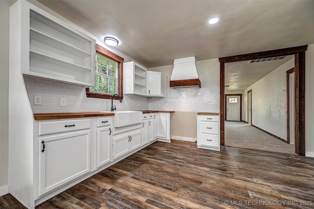 211 N 3rd St, Davis, OK 73030 - kitchen with premium range hood, open shelves, butcher block countertops, and dark wood-style floors