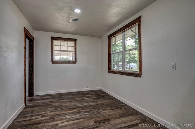 211 N 3rd St, Davis, OK 73030 - spare room with healthy amount of natural light, dark wood finished floors, and recessed lighting