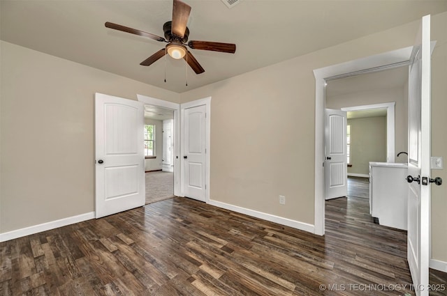 211 N 3rd St, Davis, OK 73030 - unfurnished bedroom with dark wood-style flooring and a ceiling fan