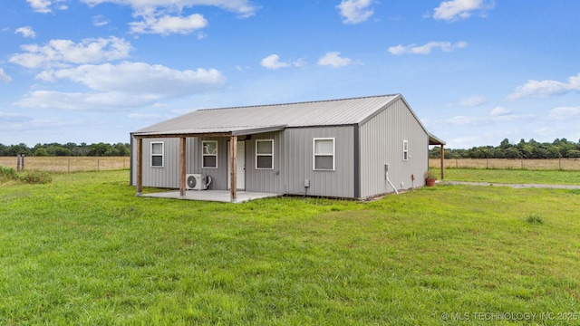 5499 S 4240th Rd, Chelsea, OK 74016 - back of property with a patio, a yard, and a metal roof
