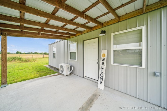 5499 S 4240th Rd, Chelsea, OK 74016 - view of exterior entry with a lawn, a patio area, and board and batten siding