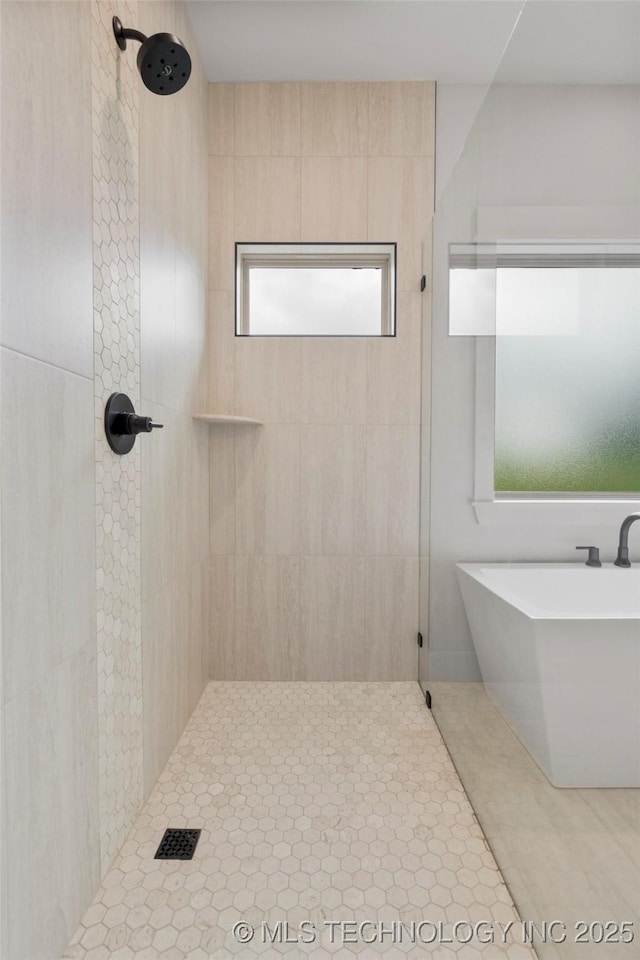 2048 E 128th Pl S, Jenks, OK 74037 - bathroom featuring tiled shower, a freestanding tub, and tile patterned flooring