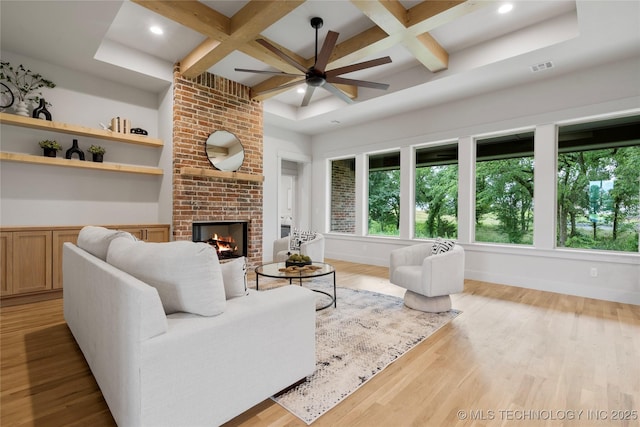 2048 E 128th Pl S, Jenks, OK 74037 - living room featuring coffered ceiling, healthy amount of natural light, a brick fireplace, ceiling fan, and wood finished floors