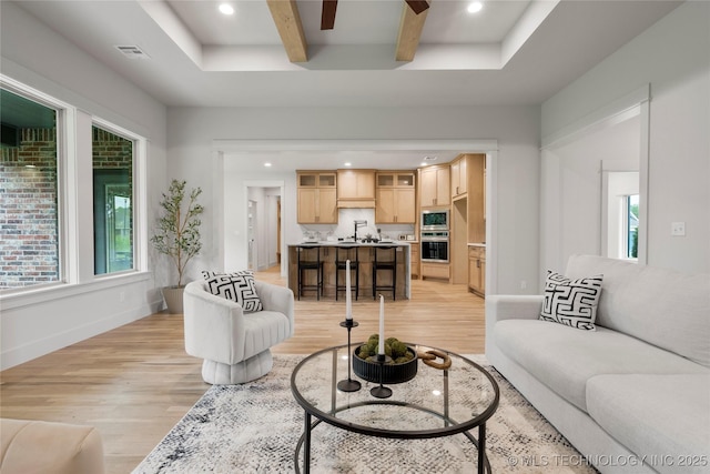 2048 E 128th Pl S, Jenks, OK 74037 - living area featuring light wood-style floors, healthy amount of natural light, beamed ceiling, recessed lighting, and a ceiling fan