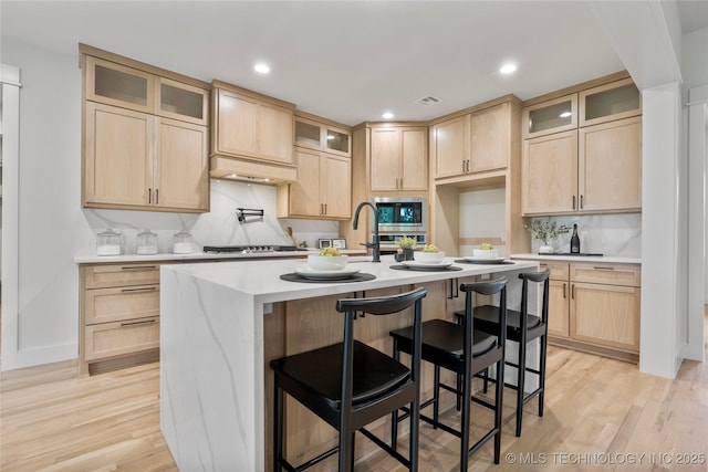 2048 E 128th Pl S, Jenks, OK 74037 - kitchen featuring light brown cabinets, stainless steel appliances, light wood-style flooring, light countertops, and recessed lighting