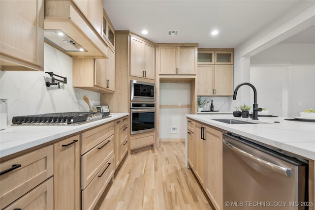 2048 E 128th Pl S, Jenks, OK 74037 - kitchen with appliances with stainless steel finishes, light brown cabinets, custom range hood, light wood-style flooring, and backsplash