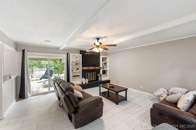 9667 E 27th St, Tulsa, OK 74129 - living room with light tile patterned flooring, ceiling fan, beam ceiling, crown molding, and a brick fireplace