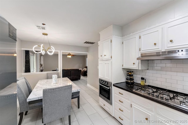 9667 E 27th St, Tulsa, OK 74129 - kitchen featuring appliances with stainless steel finishes, under cabinet range hood, decorative backsplash, white cabinetry, and a ceiling fan