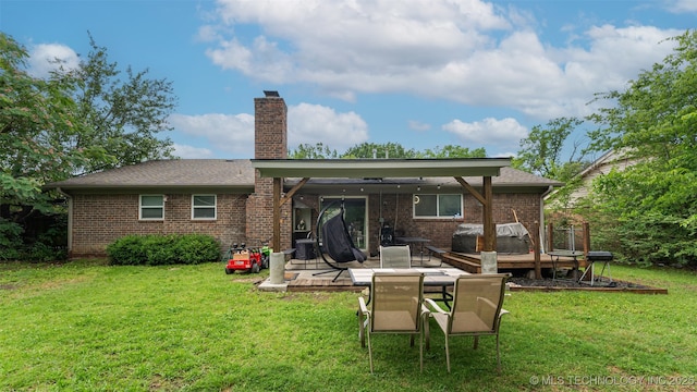 9667 E 27th St, Tulsa, OK 74129 - rear view of property featuring brick siding, a chimney, a lawn, and a patio area