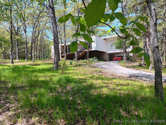 2417 Wilson St, Durant, OK 74701 - view of yard featuring stairway and asphalt driveway