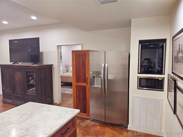 2417 Wilson St, Durant, OK 74701 - kitchen with stainless steel fridge with ice dispenser, built in microwave, recessed lighting, finished concrete floors, and light countertops