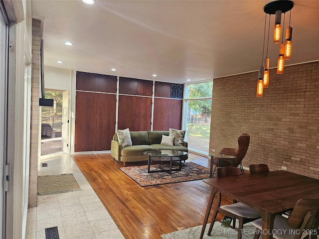 2417 Wilson St, Durant, OK 74701 - living room with brick wall, recessed lighting, and expansive windows