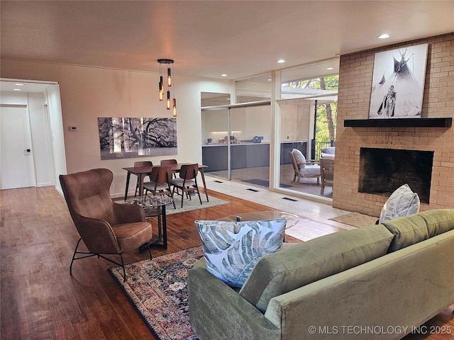 2417 Wilson St, Durant, OK 74701 - living room featuring wood finished floors, a fireplace, and recessed lighting