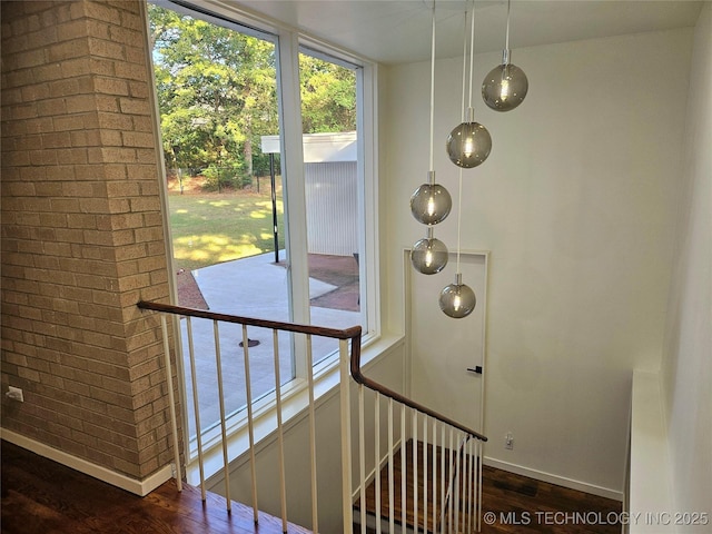 2417 Wilson St, Durant, OK 74701 - staircase with wood finished floors and brick wall