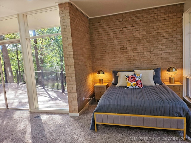 2417 Wilson St, Durant, OK 74701 - bedroom featuring access to exterior, brick wall, and carpet flooring