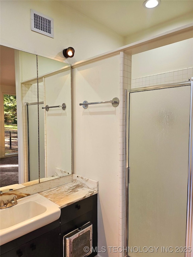 2417 Wilson St, Durant, OK 74701 - bathroom with vanity, a stall shower, and recessed lighting