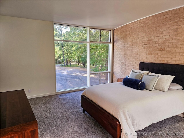 2417 Wilson St, Durant, OK 74701 - bedroom featuring brick wall and carpet floors