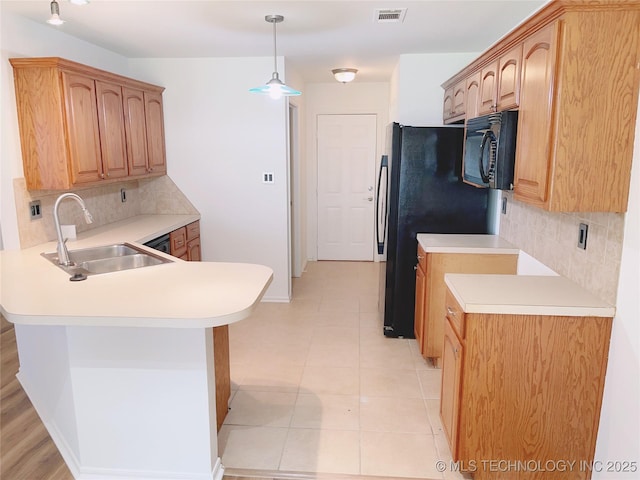 102 Northridge, Durant, OK 74701 - kitchen with black appliances, a peninsula, decorative backsplash, light countertops, and pendant lighting