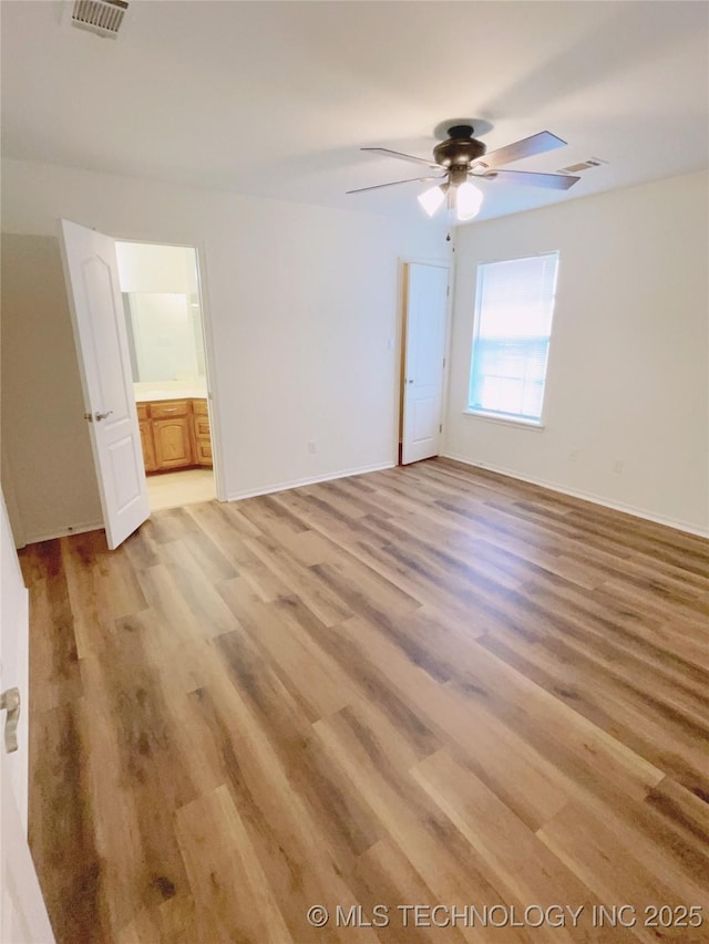 102 Northridge, Durant, OK 74701 - unfurnished bedroom featuring light wood-style floors, ceiling fan, and ensuite bathroom