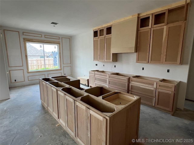 23191 E 107th St, Broken Arrow, OK 74014 - kitchen with unfinished concrete flooring, wall chimney exhaust hood, and a kitchen island