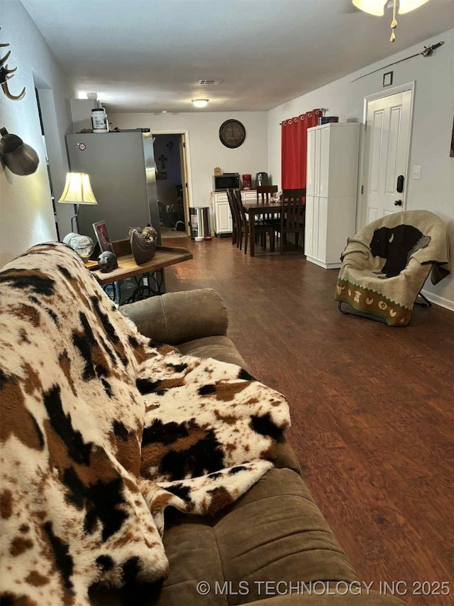 24 Lakeside, Adair, OK 74330 - living area featuring dark wood-type flooring and baseboards