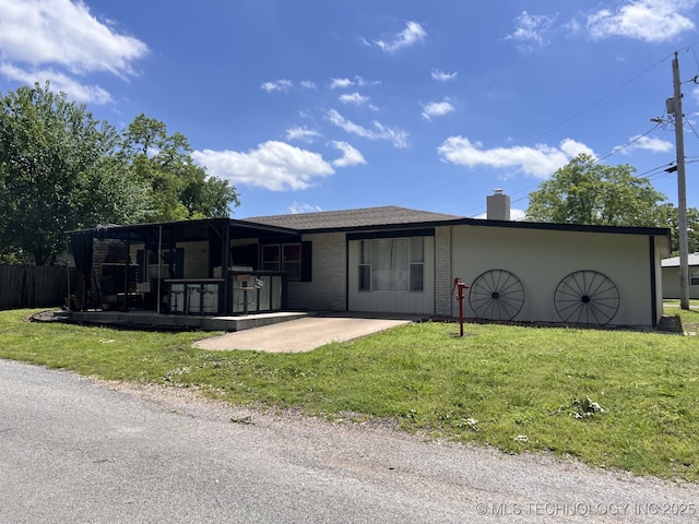 24 Lakeside, Adair, OK 74330 - view of front facade featuring a front yard, a chimney, and a patio area