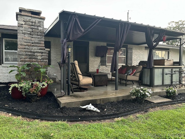 24 Lakeside, Adair, OK 74330 - back of property featuring a chimney, brick siding, and a patio