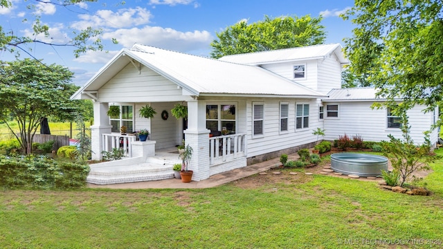 8620 N 155th Rd, Beggs, OK 74421 - rear view of property featuring covered porch, a lawn, a jacuzzi, and a metal roof