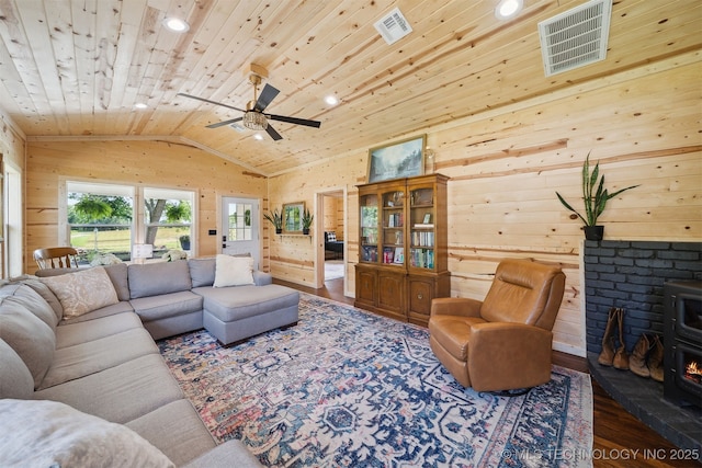 8620 N 155th Rd, Beggs, OK 74421 - living area with lofted ceiling, wood finished floors, wood ceiling, a wood stove, and ceiling fan