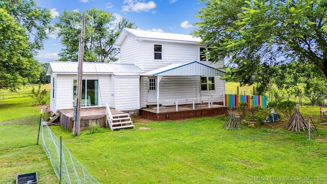 8620 N 155th Rd, Beggs, OK 74421 - back of property with a wooden deck, a fenced backyard, and a metal roof