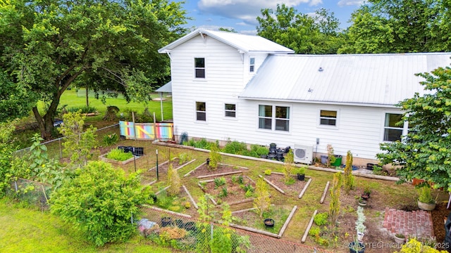 8620 N 155th Rd, Beggs, OK 74421 - back of house with a garden and a metal roof
