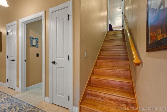 18 Longacre Dr, Ramona, OK 74061 - staircase with tile patterned floors and baseboards