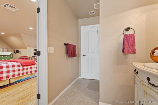 18 Longacre Dr, Ramona, OK 74061 - ensuite bathroom featuring vanity, vaulted ceiling, and tile patterned flooring