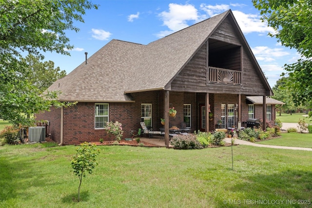 18 Longacre Dr, Ramona, OK 74061 - view of front of house with a balcony, brick siding, a front lawn, a patio, and roof with shingles