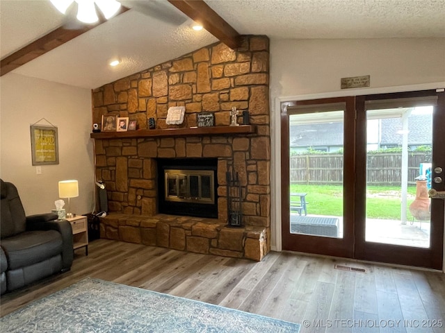 3800 S Narcissus Ave, Broken Arrow, OK 74011 - living area featuring wood finished floors, a fireplace, and a textured ceiling