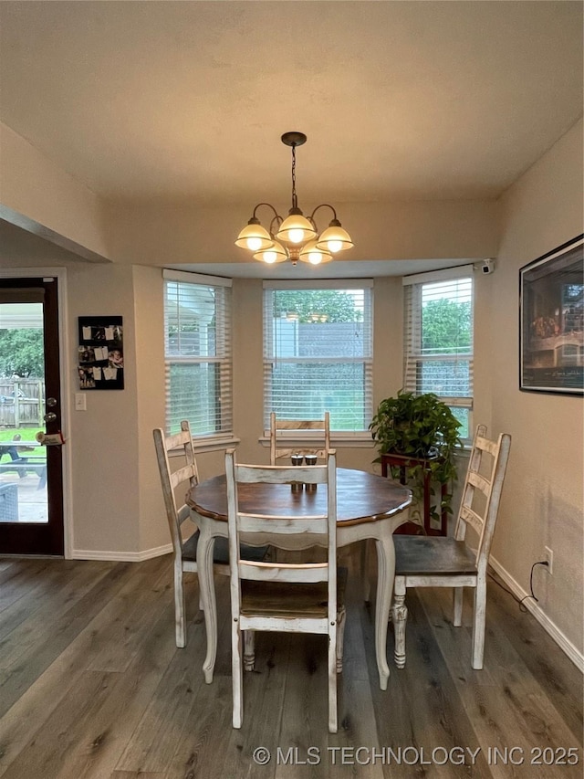 3800 S Narcissus Ave, Broken Arrow, OK 74011 - dining space with wood finished floors and a chandelier