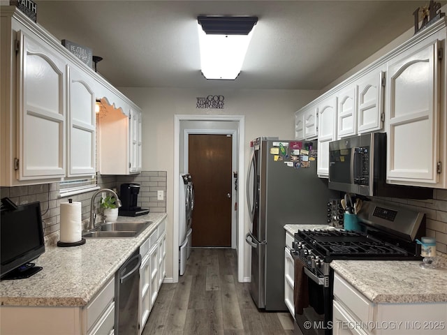 3800 S Narcissus Ave, Broken Arrow, OK 74011 - kitchen featuring appliances with stainless steel finishes, wood finished floors, white cabinetry, light countertops, and backsplash