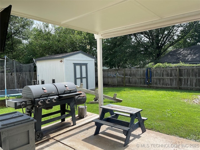 3800 S Narcissus Ave, Broken Arrow, OK 74011 - fenced backyard with a trampoline, a storage unit, a patio, and area for grilling