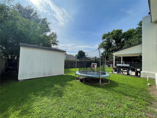 3800 S Narcissus Ave, Broken Arrow, OK 74011 - fenced backyard featuring a trampoline and a storage shed
