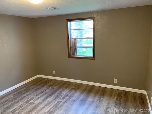 8201 State Highway 20, Eucha, OK 74342 - empty room featuring wood finished floors and baseboards